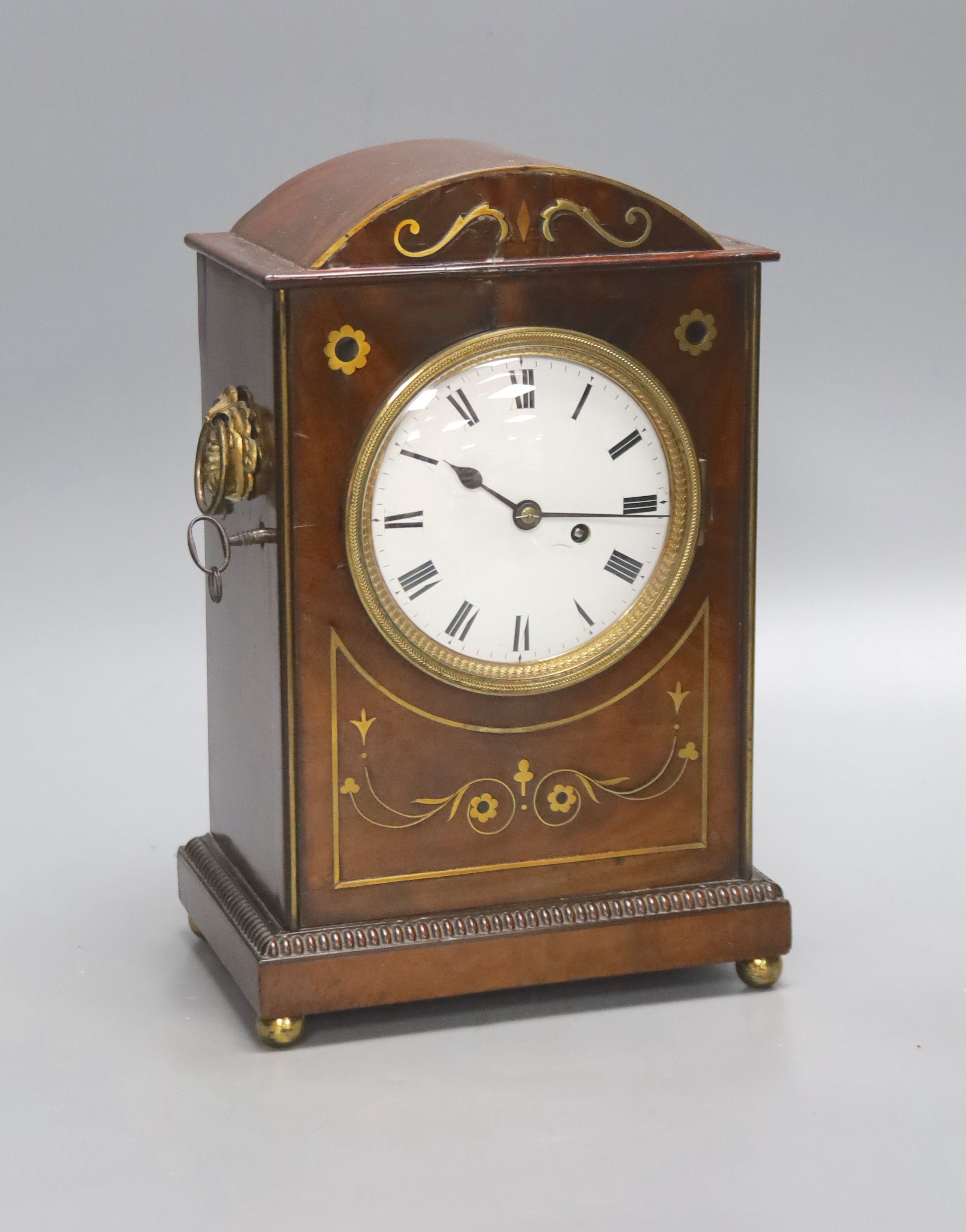 A George IV brass inlaid mahogany mantel clock, with keys and pendulum, height 28cm